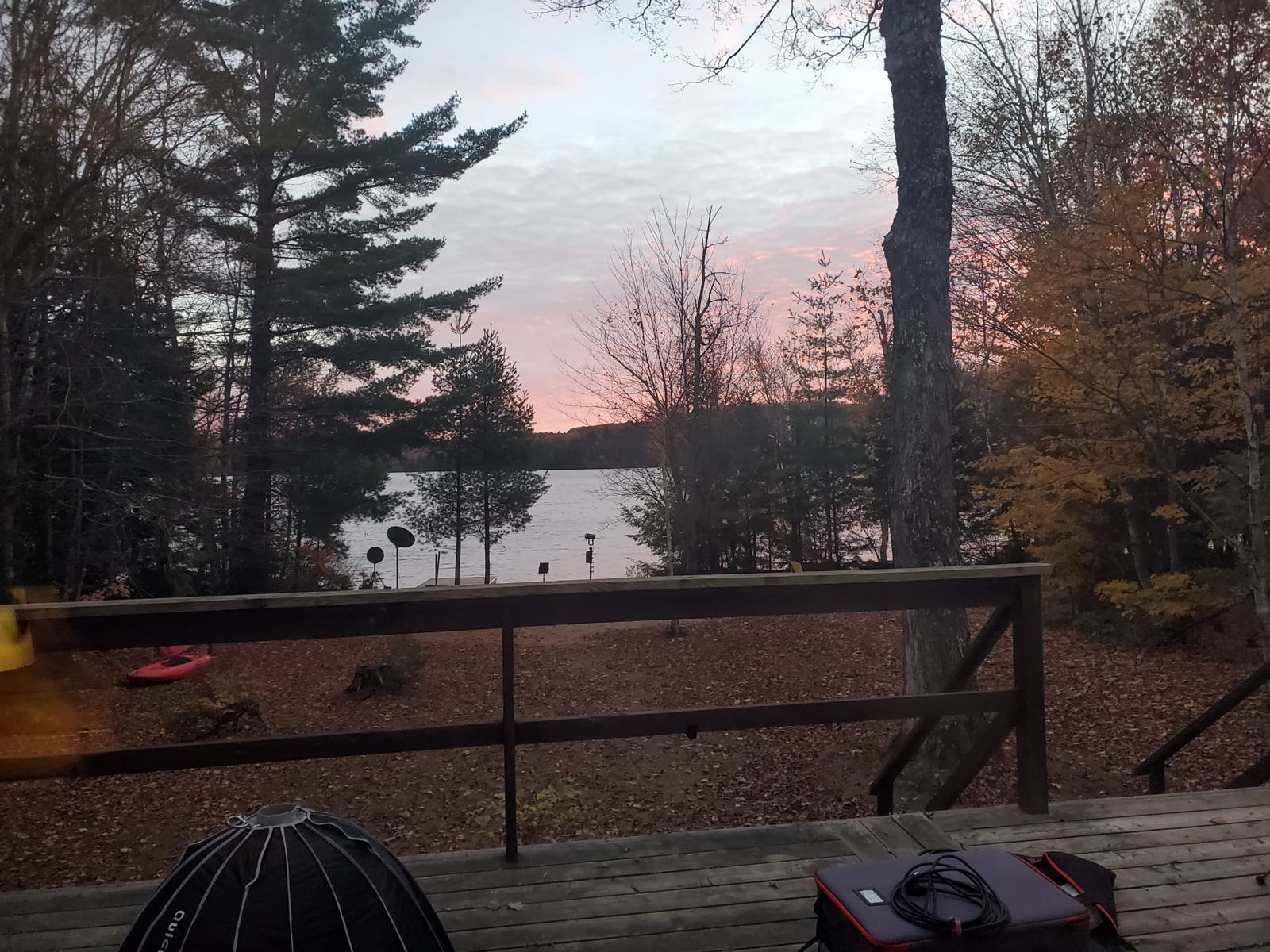 Lighting gear on the deck as the sky turns pink over the lake