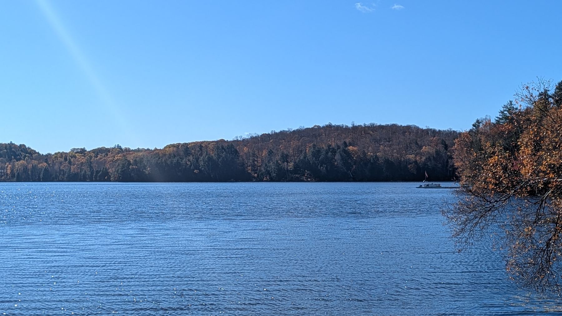 A wide lake ringed by autumn forest